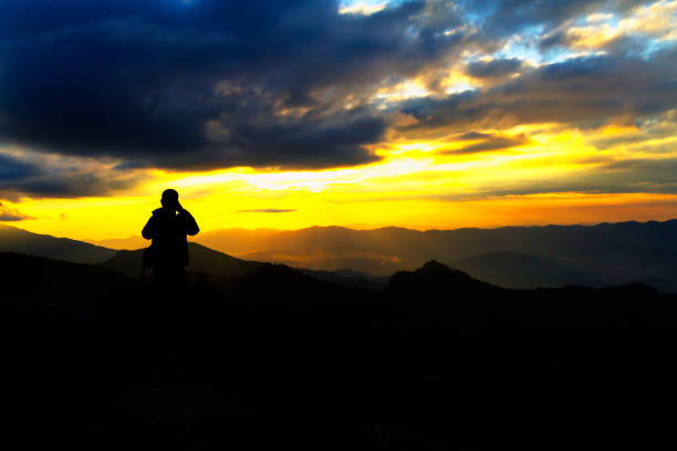 istock Sunset with black cloud and traveler on viewpoint 1172884346