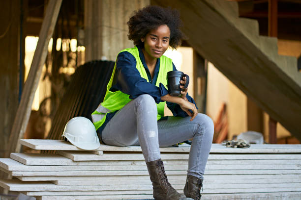 istock Smiling female engineer holding coffee at site 1172886811