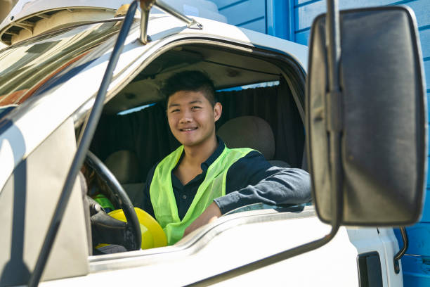 istock Smiling male construction worker sitting in truck 1172889228