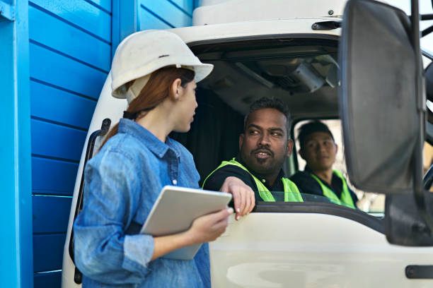 istock Female engineer discussing with male workers 1172889256