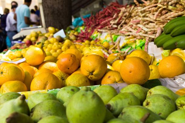 istock Green limes and oranges stacked in a fruit market (Funchal, Madeira, Portugal) 1172892771