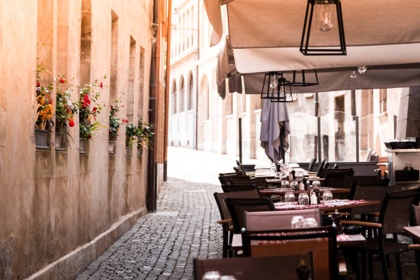 istock Outdoors restaurant terrace on narrow cobblestone street 1172894172