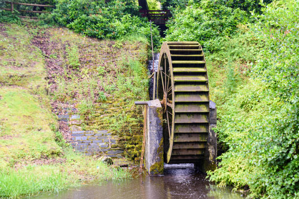 Wooden waterwheel in a garden.