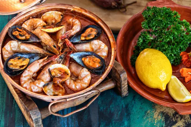 Traditional Portuguese ameijoas with clams served in a cataplana pot on the table