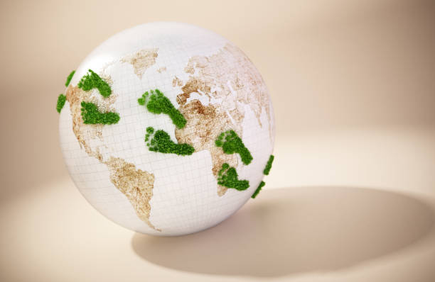 Green footprints on the globe. Copy space on the right.