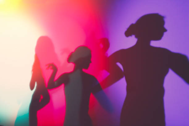Colorful background with silhouettes of women Artistic background with colorful lights and shadows of posing women ballerina shadow stock pictures, royalty-free photos & images