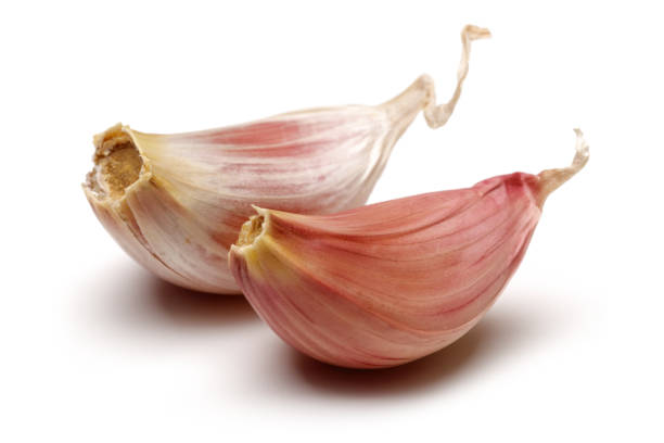 istock Two garlic cloves isolated on white 1172904666