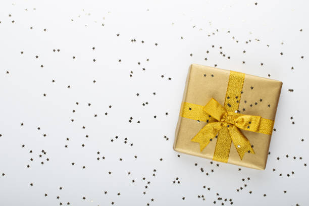 istock Gift or present box and stars confetti on color table top view. Flat lay composition for birthday, mother day or wedding. 1172905598