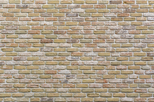 Vintage style yellow bricks wall background. Brick masonry horizontal technology architecture. Surface structure of brickwork. Close up bricks wall for designer, architect or builder