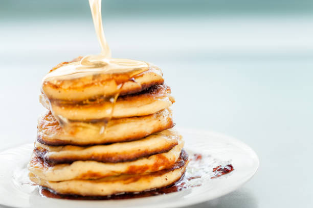 istock pancakes, spread with honey 1172908384