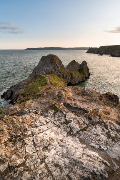 istock Beautiful peaceful Summer evening sunset beach landscape image at Three Cliffs Bay in South Wales 1172908630