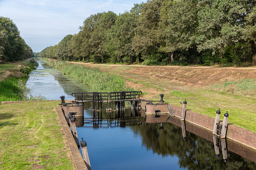 Dutch countryside in region Twente with view at canal and sluice