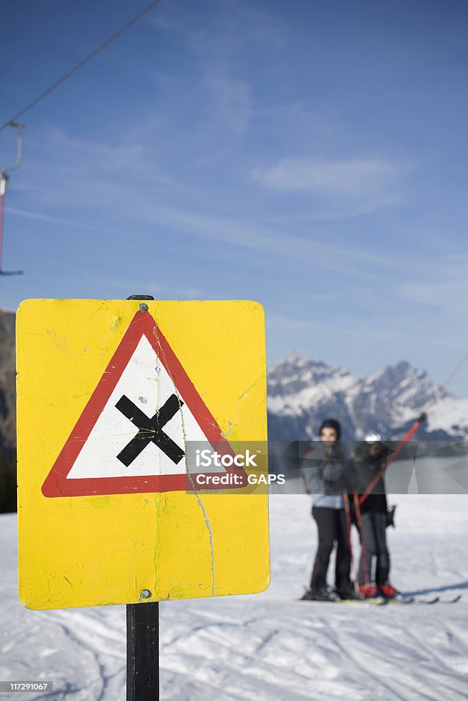 warning sign for passing skiers in a ski lift  Crossing Stock Photo