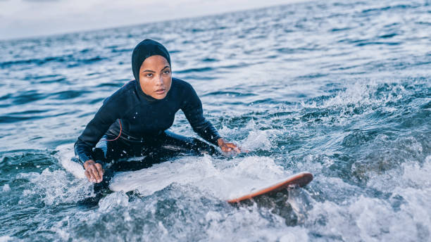 istock Female surfer with hijab in sea 1172910802