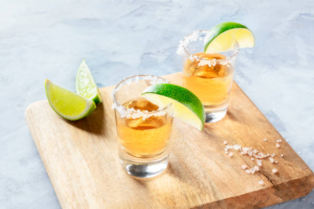 istock Golden tequila shots with lime slices and salt, with a place for text 1172910934
