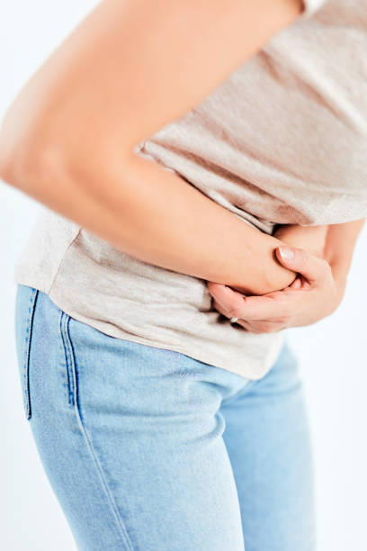 istock Woman with stomach/ hip issues / problems on the white background. 1172912252