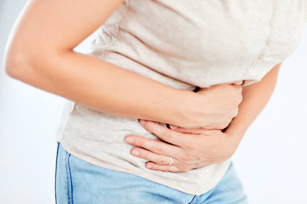 istock Woman with stomach/ hip issues / problems on the white background. 1172912286