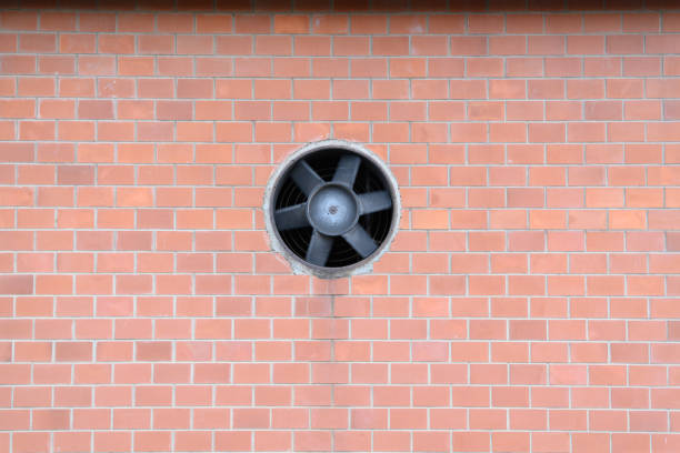 A brick wall with a rotating fan