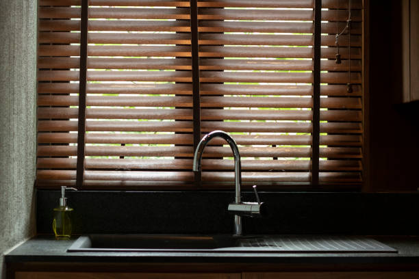 istock sink water tap counter in kitchen beside window 1172915801