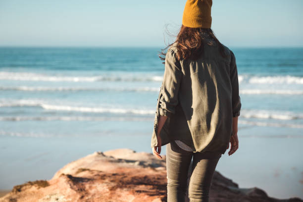 istock Beautiful woman on the beach 1172923215
