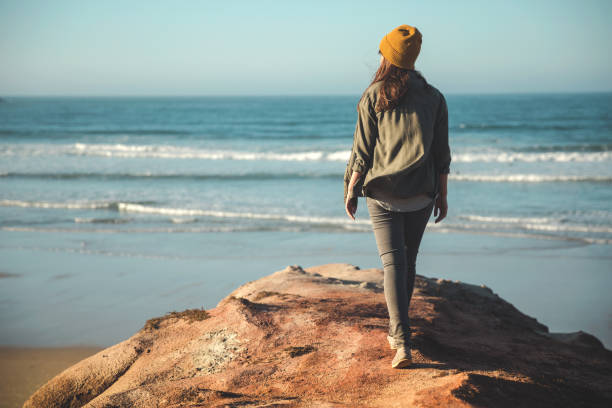 istock Beautiful woman on the beach 1172923267