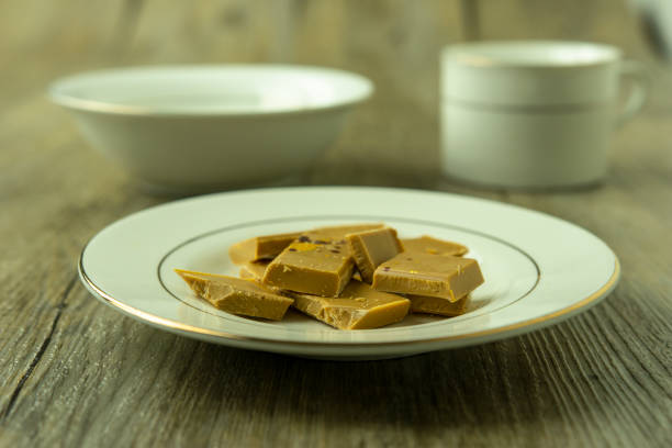 istock Gold chocolate on a wooden surface 1172926212