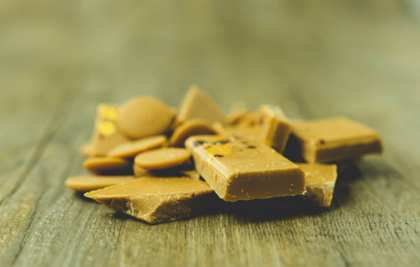 istock Gold chocolate on a wooden surface 1172927506