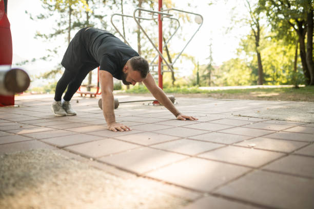 istock Young man doing push ups outdoors 1172927675