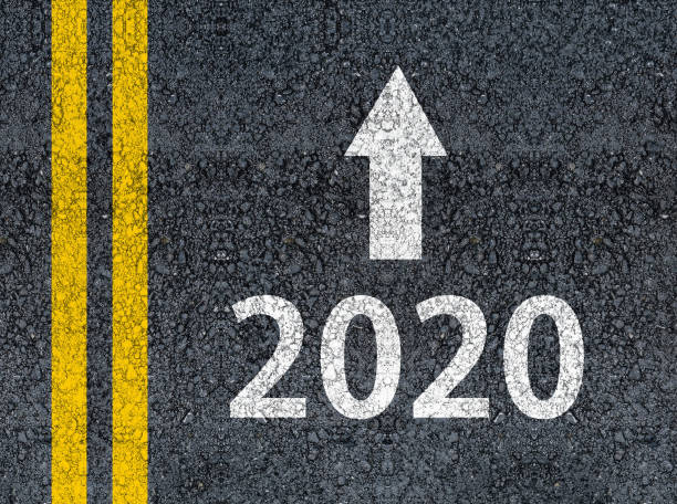 istock 2020 and an arrow written on an asphalt road 1172928279