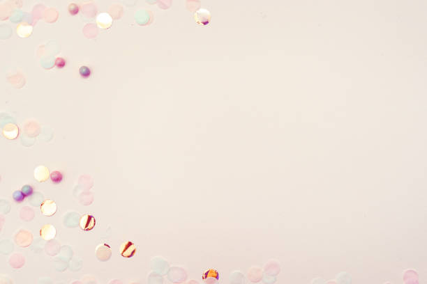 istock pastel background with confetti and parkles 1172937659