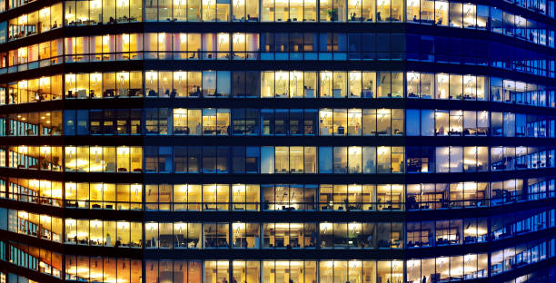istock Workers working late. Sunset to the left. Blue hour. Curved building 1172938860