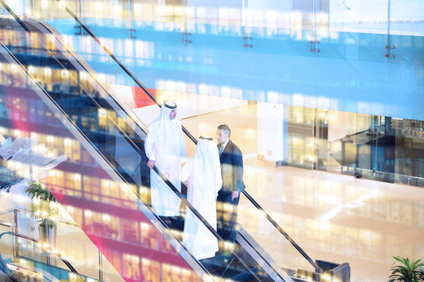 Three arab business men entering building