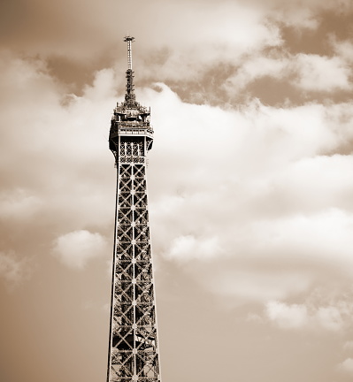 Eiffel Tower with clouds and sepia toned effect in Paris France