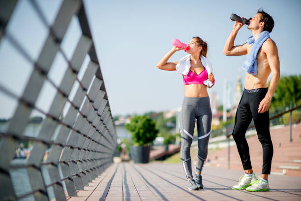 istock Young athlete people drinking water after jogging 1172943731