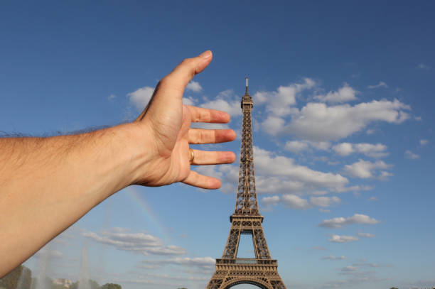 istock hadn catching the Eiffel Tower in Paris 1172943940