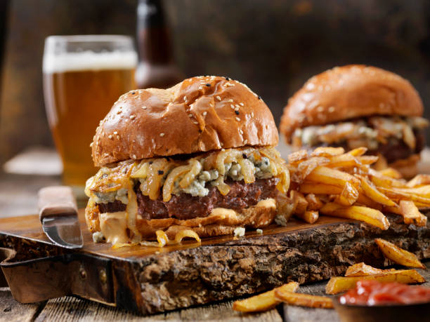 blue cheese and grilled onion venison (elk) burger with fries - beer hamburger american culture beef imagens e fotografias de stock