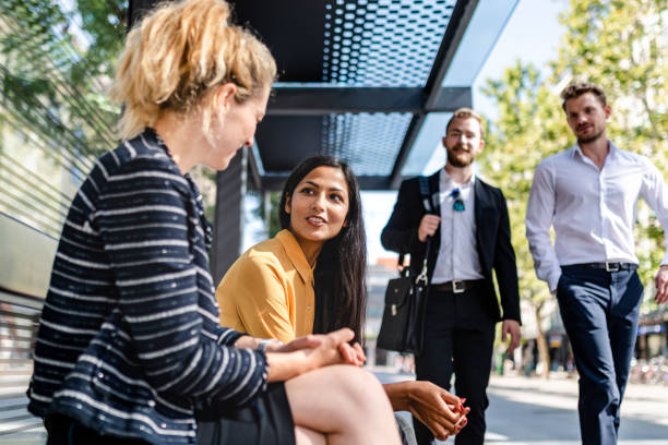 istock Business people talking at bus station 1172945126