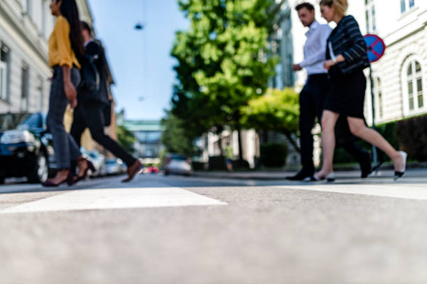 Business people walking on pedestrian crossing