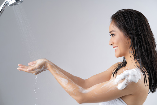 Asian woman being happy with the shower. Studio concept