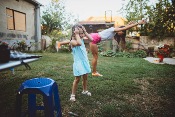 istock Daughter holding head and smiling mom doing yoga 1172951506