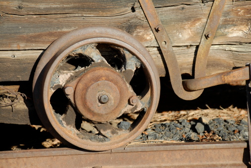 Close-up of a rusting, weather-worn historic mining cart in Colorado.