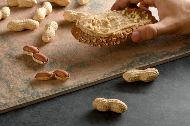 istock A male hand holding peanut butter bread with shelled peanuts 1172953278