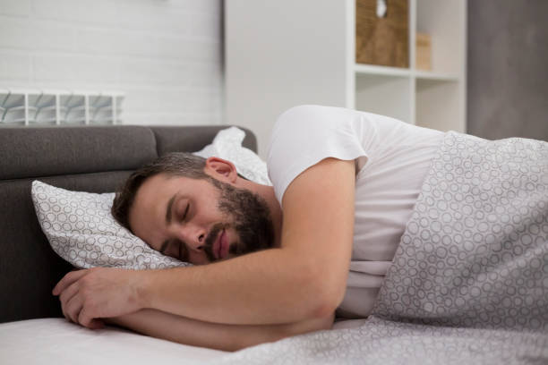 istock Man sleeping in his bedroom. It's morning. 1172954481