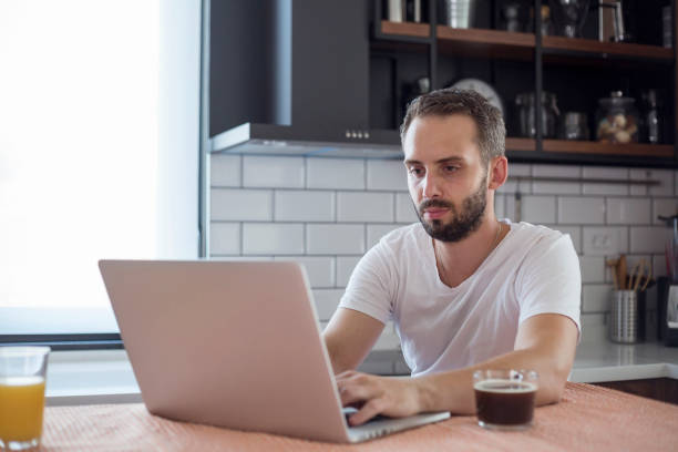 istock Focused young man working on small business start up with a laptop. 1172955919