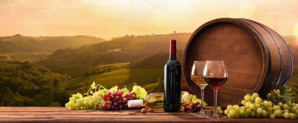 istock Wineglasses With Grapes And Barrel On A Sunny Background 1172957243