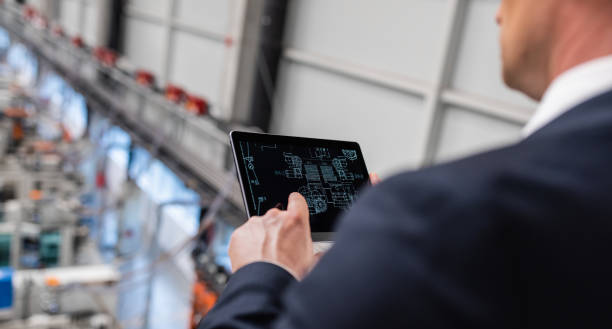 istock Businessman Using Digital Tablet In A Factory 1172957415