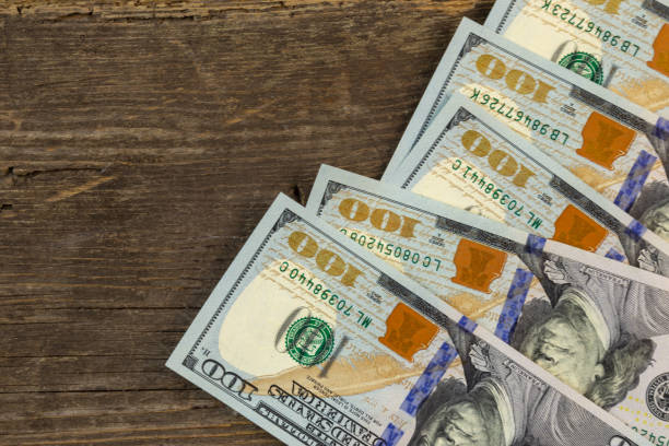 istock Rustic wooden background with US 100 dollar bill. 1172957554
