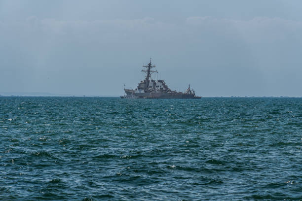 Thessaloniki, Greece - August 31 2019: USS MC Faul DDG-74 warship moored at open sea. United States Navy Arleigh Burke-class guided missile destroyer with Greek & USA flags waving outside port. stock photo