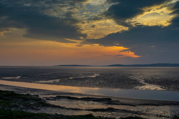 Morcombe Bay Sunset Sunset over Morecambe Bay the largest estuary in northwest England, just to the south of the Lake District National Park. It is the largest expanse of intertidal mudflats and sand in the United Kingdom, morecombe bay photos stock pictures, royalty-free photos & images