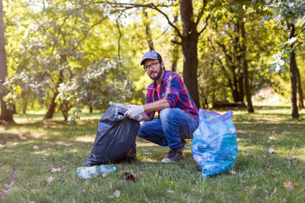 istock Young man picking up litter in his local park 1172961071